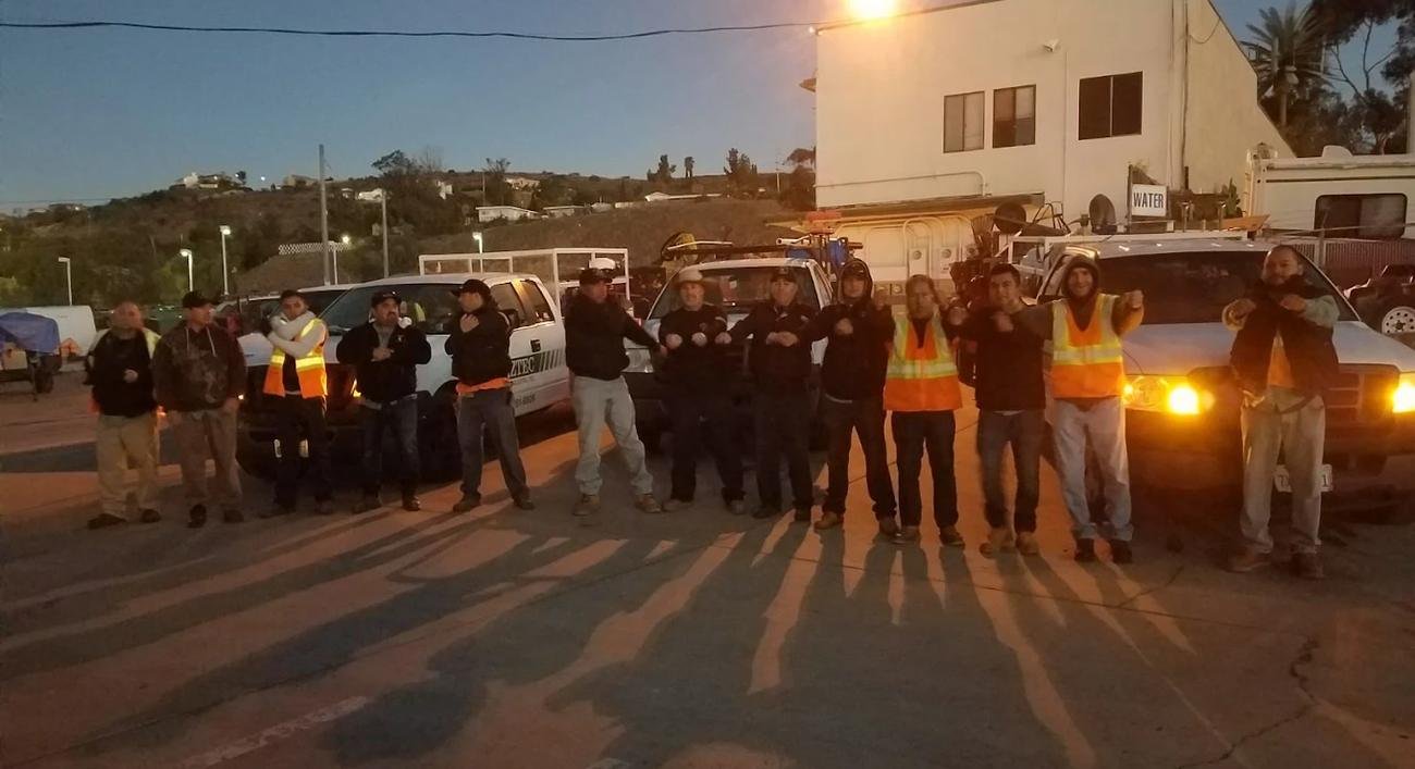 Aztec crews lined up by their trucks before sunrise