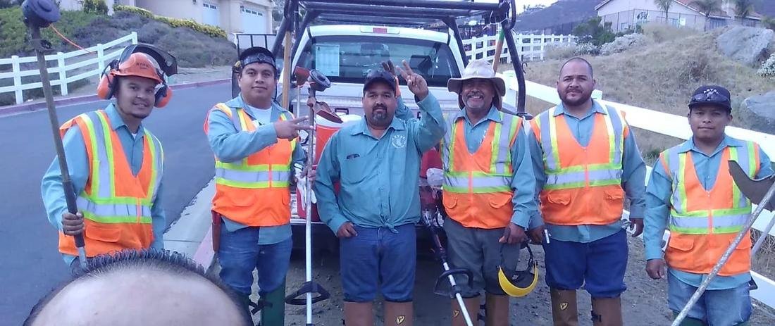 Aztec maintenance crew with trimmers and safety gear